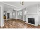 Inviting living room with a cozy fireplace and views to the kitchen at 3704 Graceland Ave, Indianapolis, IN 46208