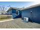 Backyard features a modern painted brick exterior and wooden deck at 3712 N Olney St, Indianapolis, IN 46218