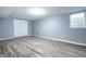 Finished basement with wood floors, recessed lighting, and closet with sliding doors at 3712 N Olney St, Indianapolis, IN 46218