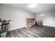 Basement with gray walls, wood-look floors, and various storage items at 3712 N Olney St, Indianapolis, IN 46218