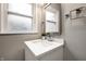 Bathroom vanity with a white countertop and a framed mirror at 3712 N Olney St, Indianapolis, IN 46218