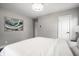 Spacious bedroom featuring a decorative painting, white walls and wood-look flooring at 3712 N Olney St, Indianapolis, IN 46218