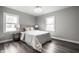 Cozy bedroom with neutral tones, wood-look flooring, and abundant natural light at 3712 N Olney St, Indianapolis, IN 46218