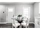 Bright dining area with stylish table set, hardwood floors, and a bright airy feel at 3712 N Olney St, Indianapolis, IN 46218