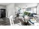 Dining area with black floors, a modern table set, and flowing transition to the living room at 3712 N Olney St, Indianapolis, IN 46218