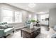Open-concept living area featuring hardwood floors, a table set, and a comfortable teal chair at 3712 N Olney St, Indianapolis, IN 46218
