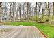 Backyard view from the wooden deck, featuring mature trees, green grass, and landscaping at 381 Stoneybrook Grove Dr, Greenwood, IN 46142