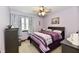 Cozy bedroom featuring a decorative ceiling fan, plush bedding, and lots of natural light at 381 Stoneybrook Grove Dr, Greenwood, IN 46142