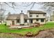 Backyard featuring wooden deck, brick patio, garden, and lush green grass at 381 Stoneybrook Grove Dr, Greenwood, IN 46142