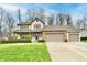 Charming two-story home with a three car garage and a well-maintained lawn and landscaping at 381 Stoneybrook Grove Dr, Greenwood, IN 46142