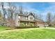 Beautiful two-story home with a large yard and mature trees under a bright blue sky at 381 Stoneybrook Grove Dr, Greenwood, IN 46142