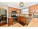 An open kitchen features stainless steel appliances, a stone backsplash, and light wood cabinets at 381 Stoneybrook Grove Dr, Greenwood, IN 46142