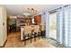 This kitchen features a bar area with seating and sliding glass doors leading to the outside deck at 381 Stoneybrook Grove Dr, Greenwood, IN 46142