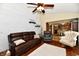 Open living room features hardwood floors, comfortable seating, a ceiling fan, and access to the kitchen at 381 Stoneybrook Grove Dr, Greenwood, IN 46142
