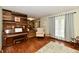 Cozy living area with a piano, hardwood floors, a decorative wall, and natural light at 381 Stoneybrook Grove Dr, Greenwood, IN 46142