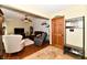 Open living room features hardwood floors, comfortable seating, and a decorative wooden front door at 381 Stoneybrook Grove Dr, Greenwood, IN 46142