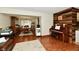 Inviting living room area open to the dining room featuring hardwood floors and natural lighting at 381 Stoneybrook Grove Dr, Greenwood, IN 46142