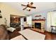 This living room features a stone fireplace, hardwood floors, and is conveniently connected to the kitchen at 381 Stoneybrook Grove Dr, Greenwood, IN 46142