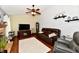 Comfortable living room features hardwood floors, comfortable seating, a ceiling fan, and a fireplace at 381 Stoneybrook Grove Dr, Greenwood, IN 46142