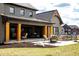 Covered back patio with ample seating and dark trim exterior accents at 3899 Chapel Hill Ct, Bargersville, IN 46106