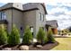 The side of the house features tall trees, green grass, and a view of the porch at 3899 Chapel Hill Ct, Bargersville, IN 46106