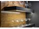 Close up of bar area shelving, featuring wood paneling and illuminated shelves with stemware at 3899 Chapel Hill Ct, Bargersville, IN 46106