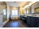 Bright bathroom features a soaking tub, glass shower, and dual vanity with modern fixtures and dark wood floors at 3899 Chapel Hill Ct, Bargersville, IN 46106