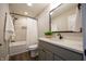 Bathroom featuring a bathtub, shower with tile surround, and vanity with black fixtures and a neutral countertop at 3899 Chapel Hill Ct, Bargersville, IN 46106