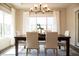 Bright dining room with natural light, table with seating for six, and elegant chandelier at 3899 Chapel Hill Ct, Bargersville, IN 46106