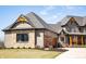 Attractive two-story home with stone accents, a three-car garage, and a cozy front porch at 3899 Chapel Hill Ct, Bargersville, IN 46106