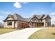 Elegant two-story home boasting a three-car garage, stone accents, and a welcoming front porch at 3899 Chapel Hill Ct, Bargersville, IN 46106