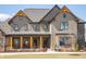 Inviting front porch with wooden posts, comfortable seating, and decorative accents at 3899 Chapel Hill Ct, Bargersville, IN 46106