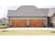 Spacious three-car garage with wooden doors and well-maintained landscaping at 3899 Chapel Hill Ct, Bargersville, IN 46106