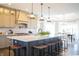 A bright, open kitchen featuring a large center island with stool seating and decorative pendant lights at 3899 Chapel Hill Ct, Bargersville, IN 46106