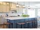 A bright, open kitchen featuring a large center island with stool seating and decorative pendant lights at 3899 Chapel Hill Ct, Bargersville, IN 46106