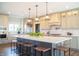 Open concept kitchen features a large island with barstool seating and sleek stainless steel appliances at 3899 Chapel Hill Ct, Bargersville, IN 46106