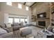 Open concept living room boasts stone fireplace, exposed beams, and access to outdoor patio area at 3899 Chapel Hill Ct, Bargersville, IN 46106
