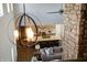 View from above of the kitchen and living room; open floor plan, beams and brick accent wall at 3899 Chapel Hill Ct, Bargersville, IN 46106