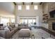 Spacious living room with a stone fireplace, wood beams, large windows, and a comfortable sectional sofa at 3899 Chapel Hill Ct, Bargersville, IN 46106