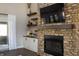 Living room featuring a stone fireplace, custom built-ins, and view to a covered patio at 3899 Chapel Hill Ct, Bargersville, IN 46106