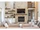 Spacious living room featuring a stone fireplace, floating shelves, and comfortable seating at 3899 Chapel Hill Ct, Bargersville, IN 46106