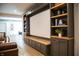 Living room with built-in shelving and cabinets, bench seating, and modern decor and furnishings at 3899 Chapel Hill Ct, Bargersville, IN 46106