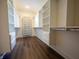 Bright walk-in closet with laminate floors and custom shelving provides ample storage space at 3899 Chapel Hill Ct, Bargersville, IN 46106