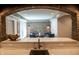 View from wet bar into living room, showcasing brick accent wall and seating area at 3899 Chapel Hill Ct, Bargersville, IN 46106