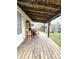 Wooden back porch with rocking chairs and view of fenced-in yard at 3949 Fletcher Ave, Indianapolis, IN 46203