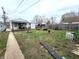 Backyard with grass, fire pit, storage shed and mature trees at 3949 Fletcher Ave, Indianapolis, IN 46203