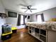 Comfortable bedroom with hardwood floors, a ceiling fan, and a large window at 3949 Fletcher Ave, Indianapolis, IN 46203