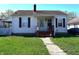 Charming home with a well-maintained front yard and walkway leading to the cozy front porch at 3949 Fletcher Ave, Indianapolis, IN 46203