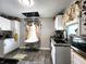 Well-lit kitchen featuring granite counters, stainless appliances, and hanging pot rack above an island at 3949 Fletcher Ave, Indianapolis, IN 46203