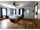 Bright living room featuring hardwood floors, a ceiling fan, and a large window at 3949 Fletcher Ave, Indianapolis, IN 46203
